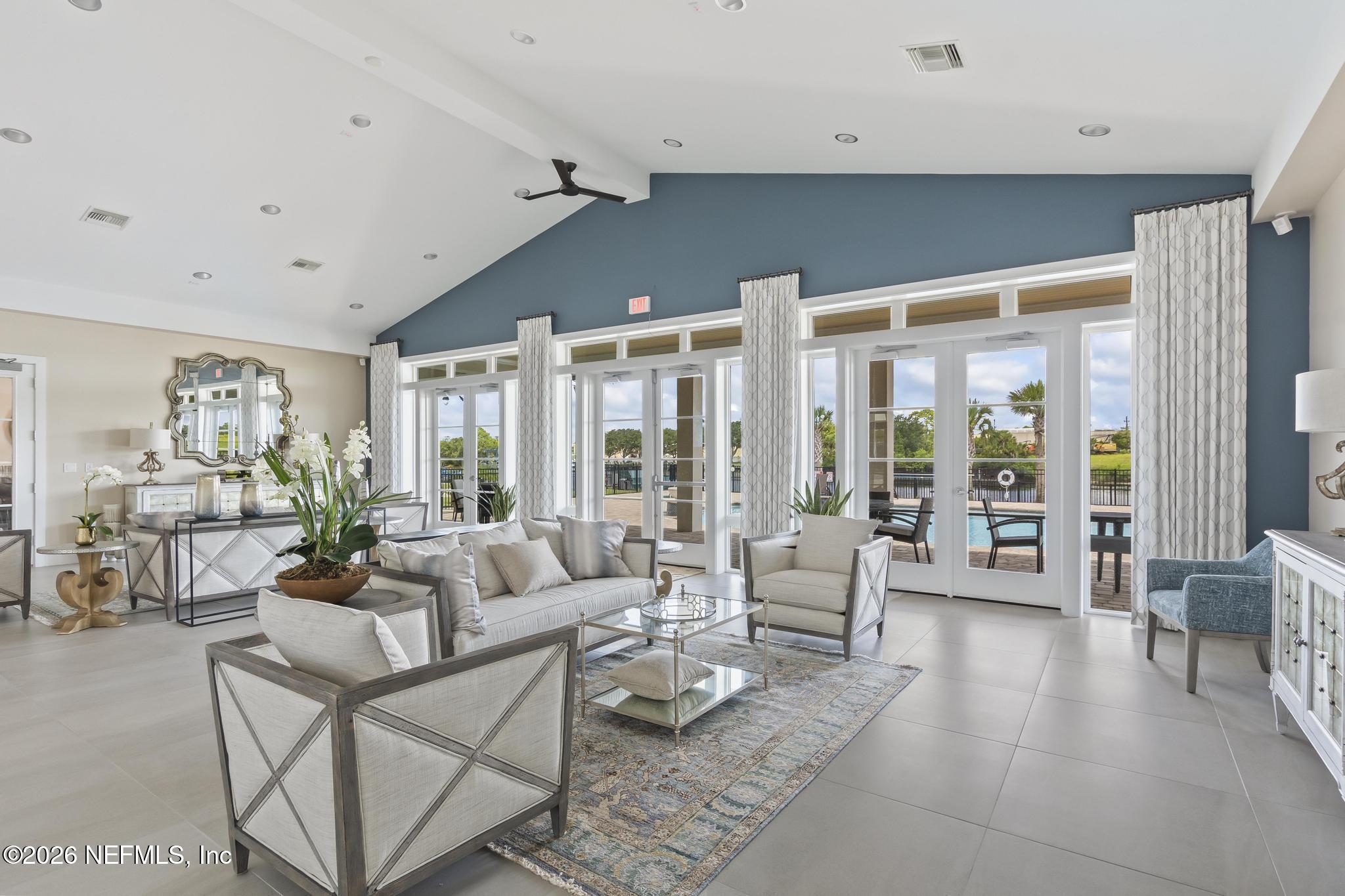 2 Menorca Way Palm Coast, FL 32137 - Photo 23 of 37 a living room with furniture large window and glass table