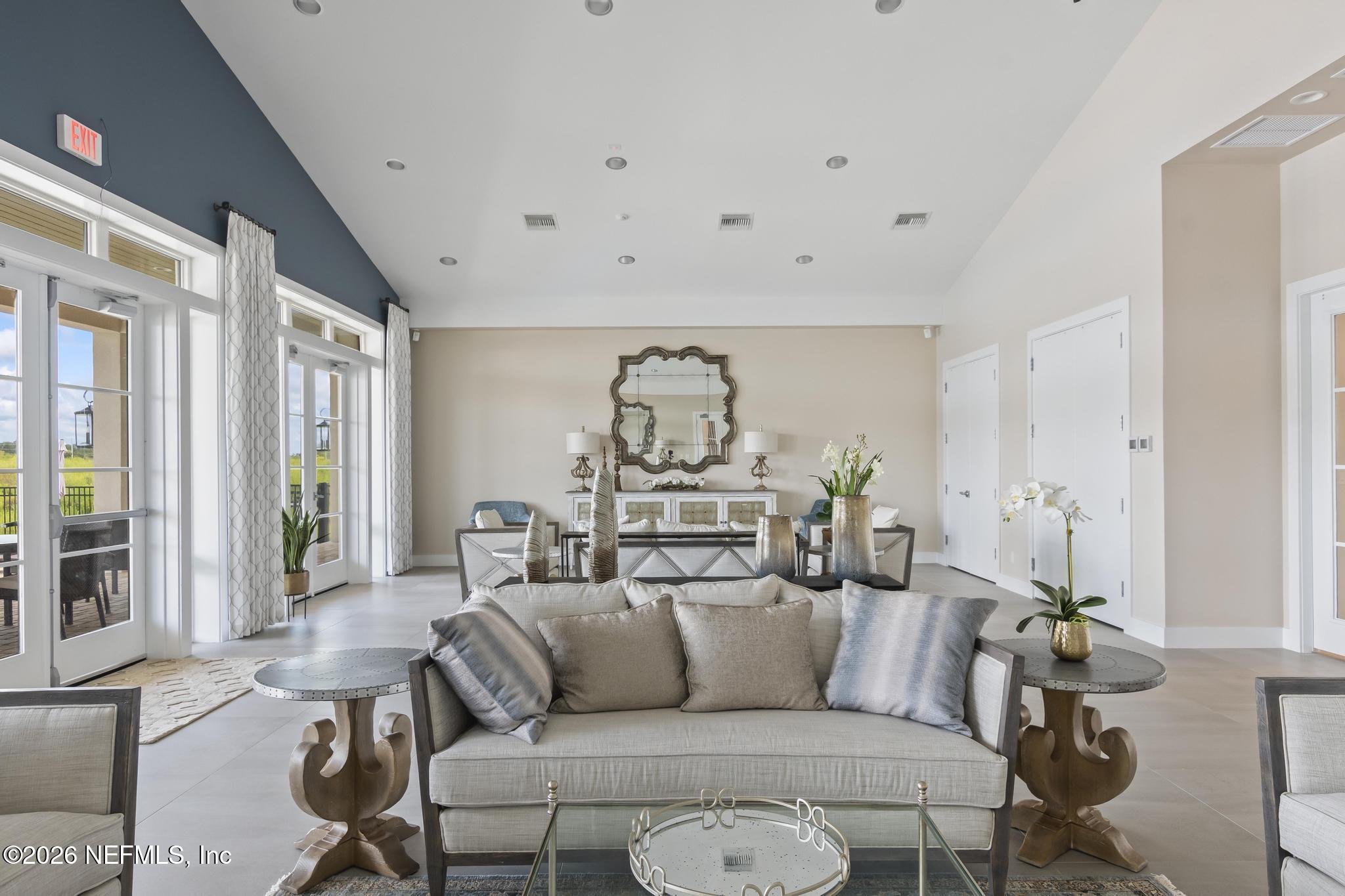 2 Menorca Way Palm Coast, FL 32137 - Photo 25 of 37 a living room with furniture a rug and a chandelier