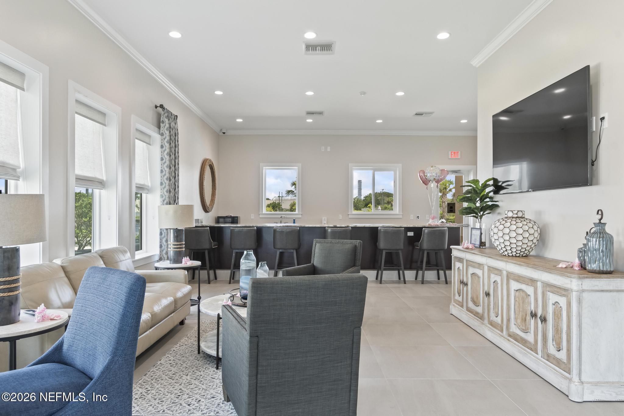 2 Menorca Way Palm Coast, FL 32137 - Photo 31 of 37 a living room with furniture a flat screen tv and a large window