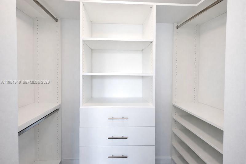 45 Southwest 9th Street, Unit 1208 Miami, FL 33130 - Photo 13 of 27 a view of walk in closet with empty racks