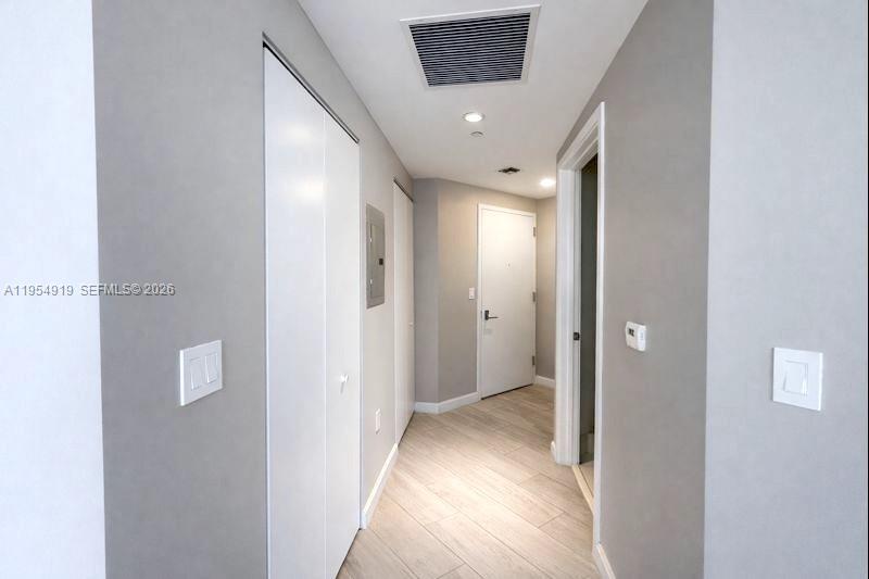 45 Southwest 9th Street, Unit 1208 Miami, FL 33130 - Photo 16 of 27 a view of a hallway with wooden floor