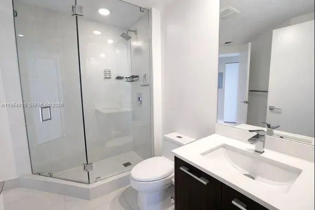 a bathroom with a sink toilet and shower