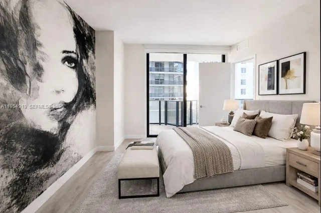 a bedroom with a bed and a flat screen tv