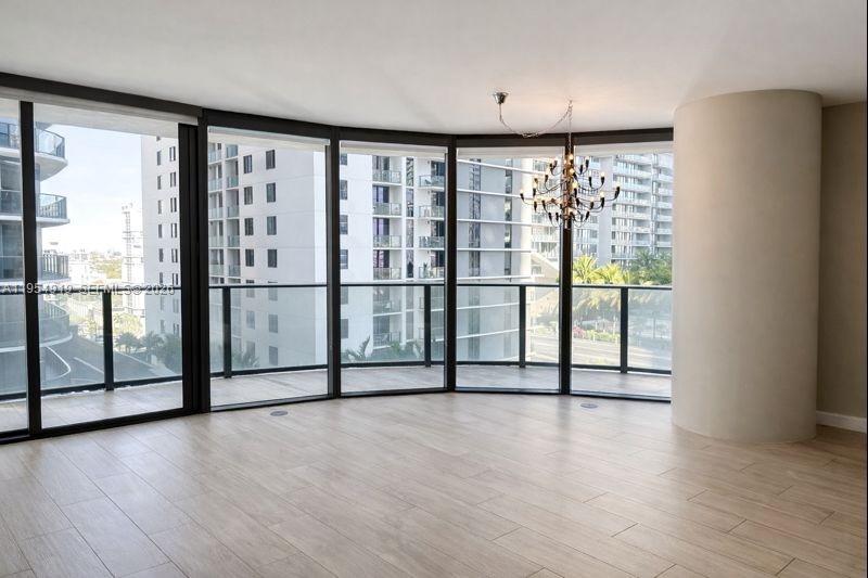 45 Southwest 9th Street, Unit 1208 Miami, FL 33130 - Photo 4 of 27 an empty room with sliding door and mountain view