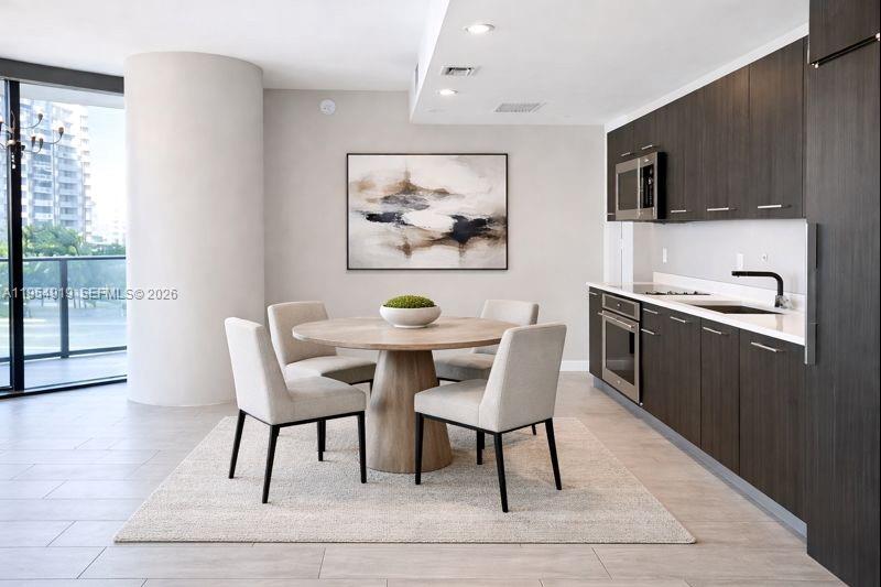 45 Southwest 9th Street, Unit 1208 Miami, FL 33130 - Photo 8 of 27 a view of a dining room with furniture and wooden floor