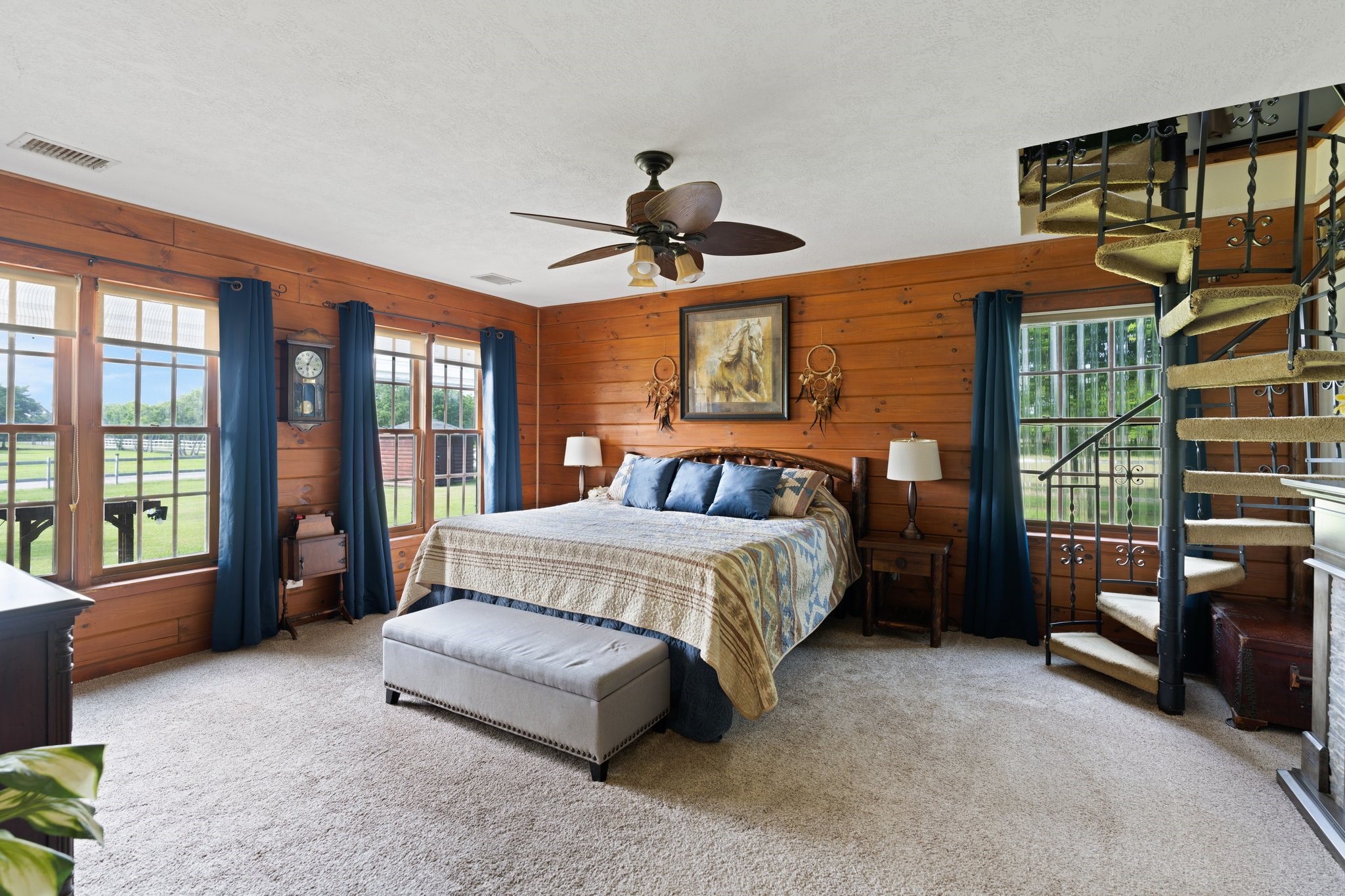 8226 Fm 2354 Beach Baytown, TX 77523 - Photo 18 of 39 With exposed real log wood walls and pasture views make the ground floor primary suite a peaceful retreat. The spiral staircase leads to the upstairs home office.