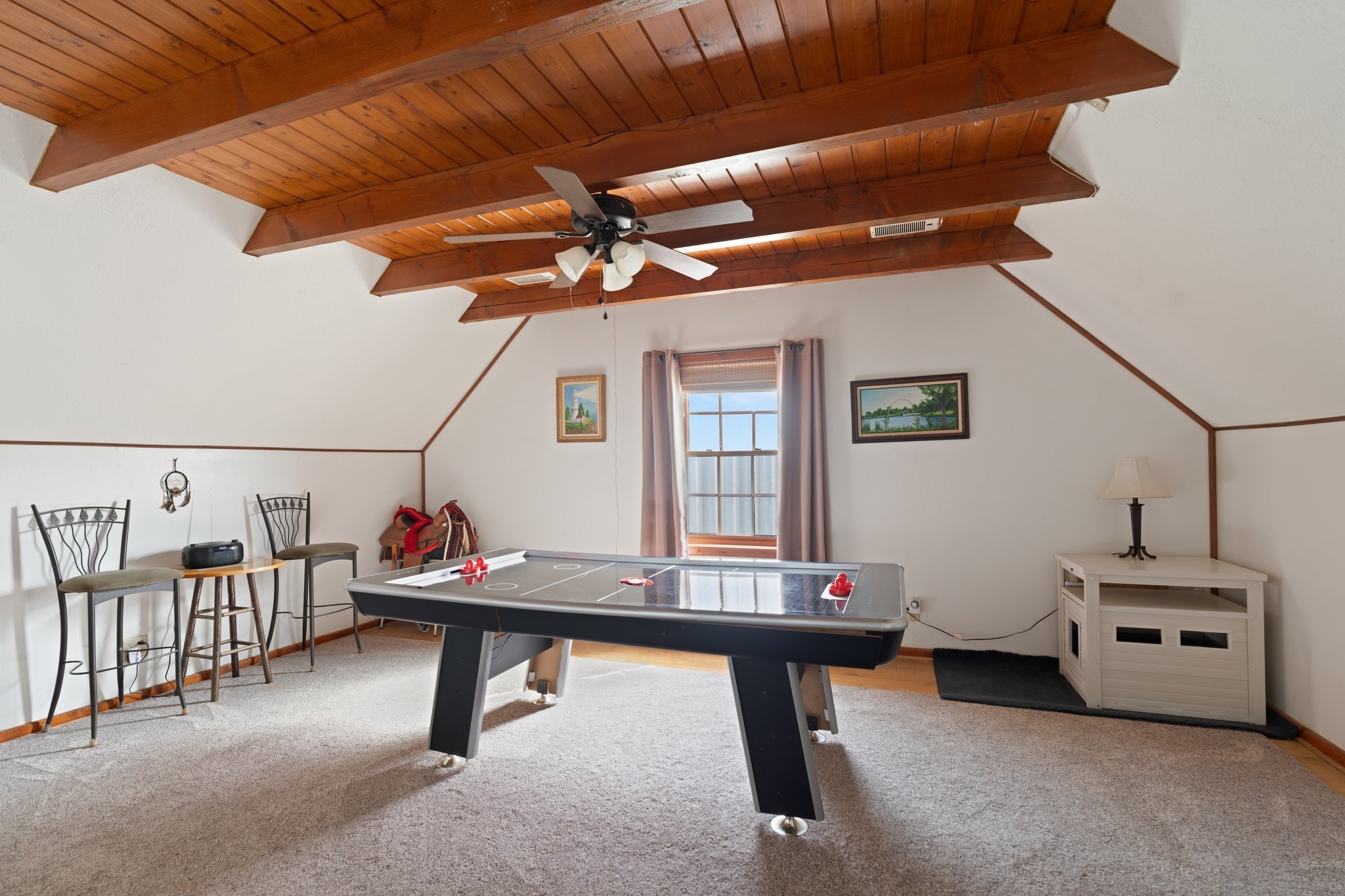 8226 Fm 2354 Beach Baytown, TX 77523 - Photo 23 of 39 Upstairs, the game room features warm wood flooring, beamed ceilings, and plenty of space for play or relaxation.