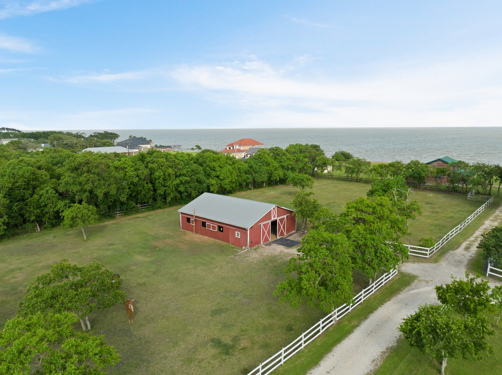 8226 Fm 2354 Beach Baytown, TX 77523 - Photo 7 of 39 A 7-stall barn with tack room, equipment storage, and wash area is ready for use on the 5+ acres of fully fenced pasture