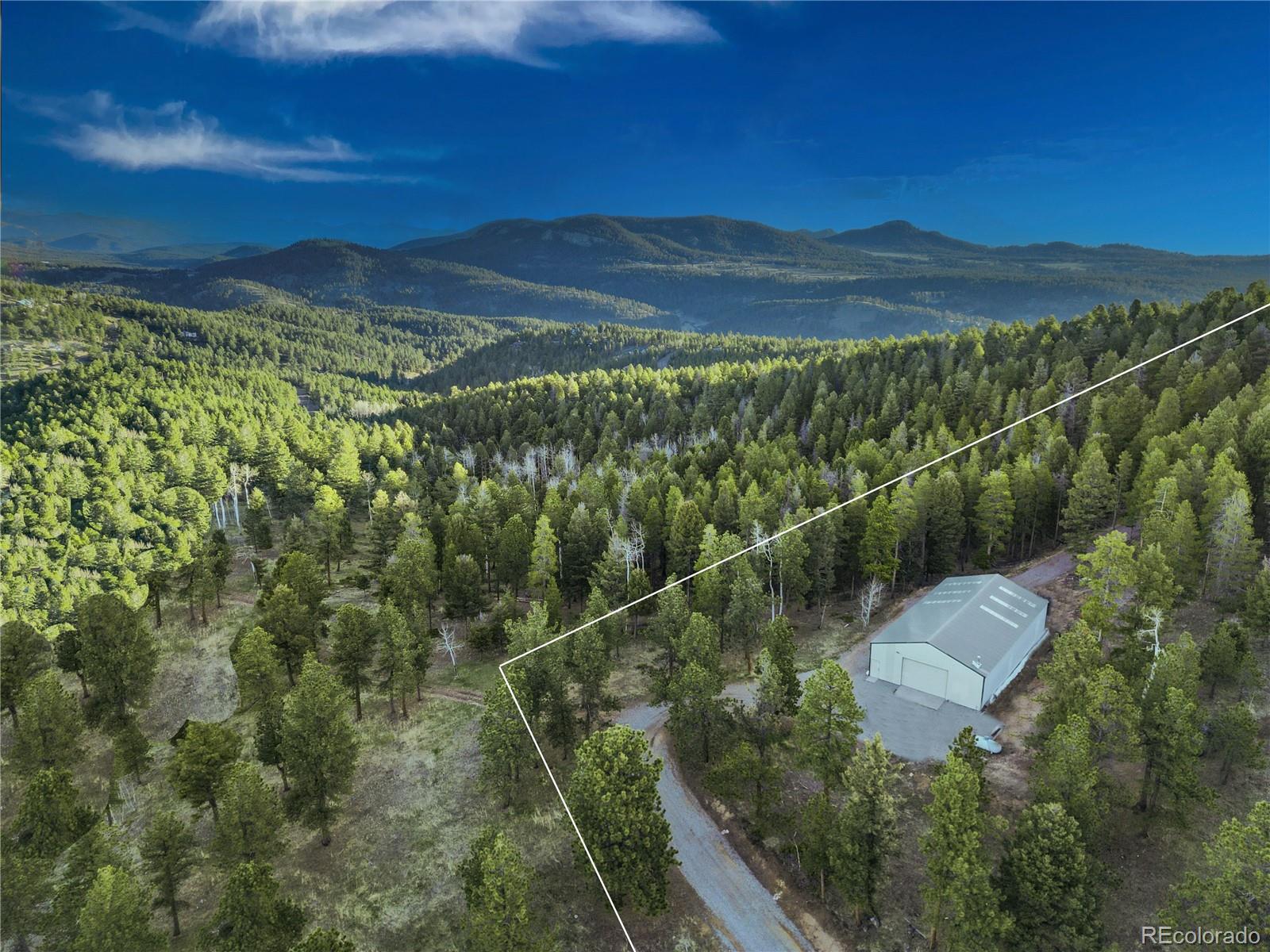 26273 Richmond Hill Road Conifer, CO 80433 - Photo 21 of 47 a view of a mountain from a balcony