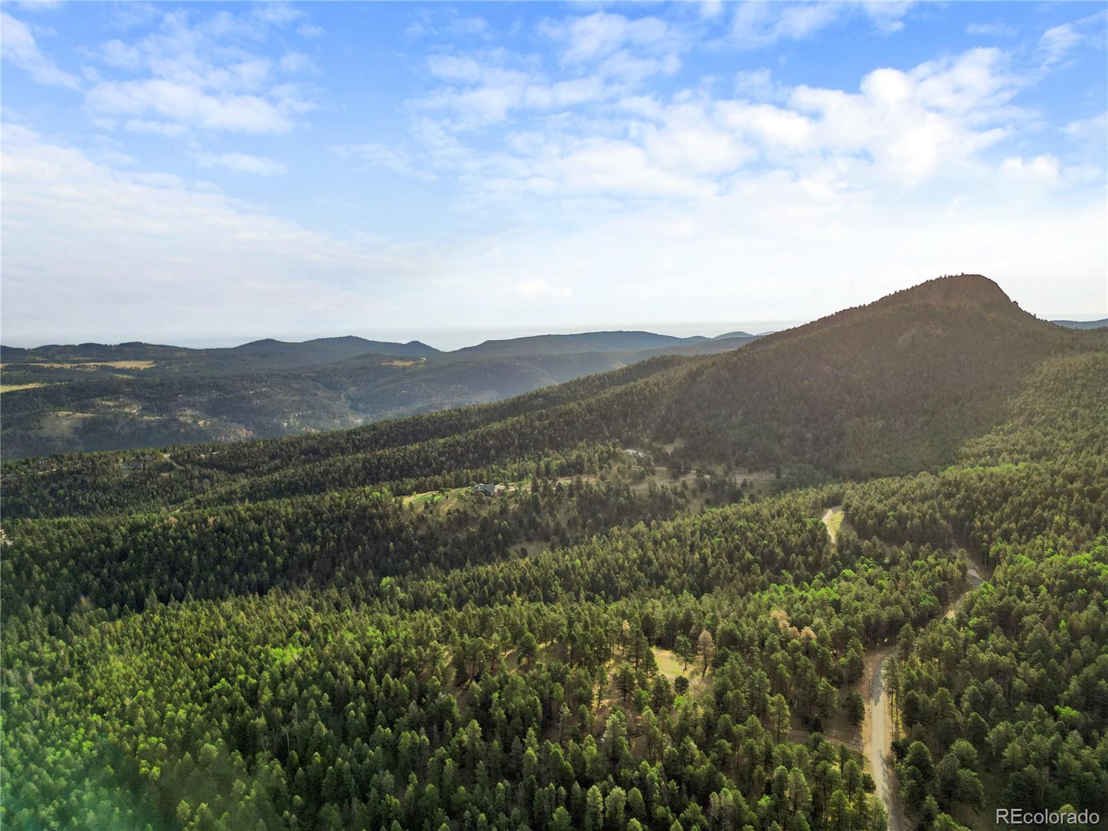 26273 Richmond Hill Road Conifer, CO 80433 - Photo 37 of 47 a view of a mountain range with lush green forest