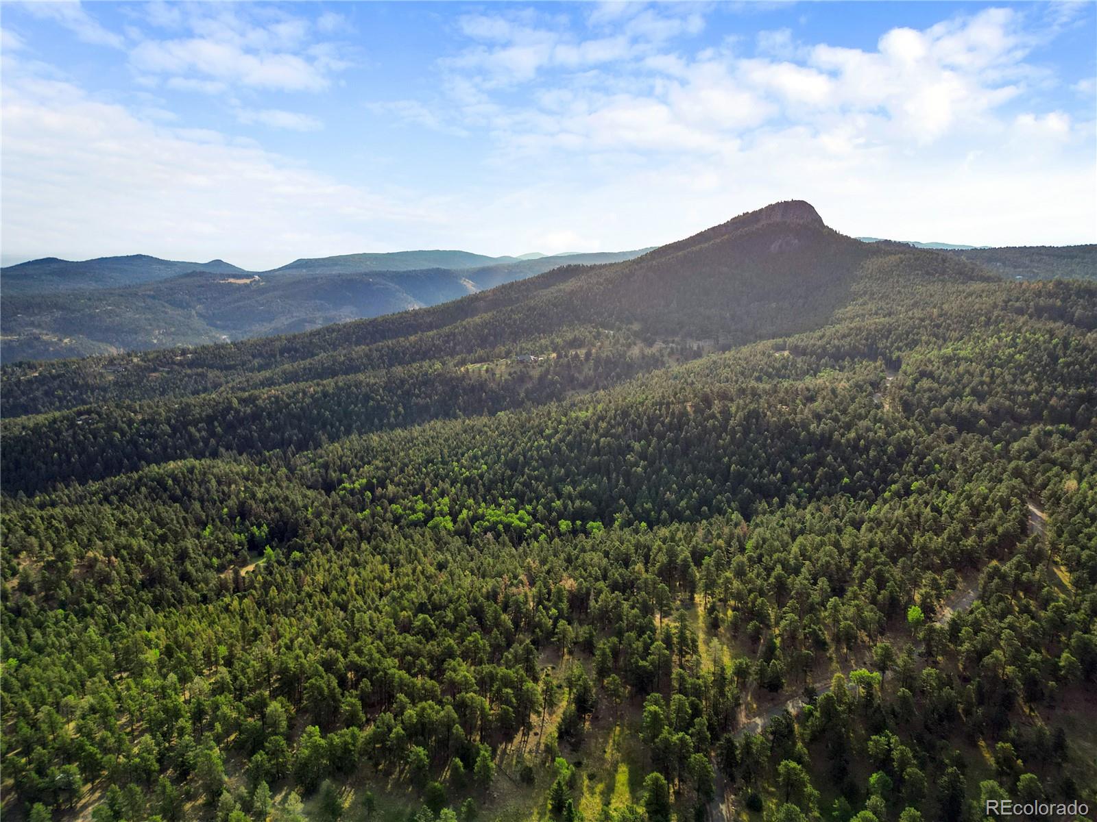 26273 Richmond Hill Road Conifer, CO 80433 - Photo 39 of 47 a view of a mountain range with lush green forest