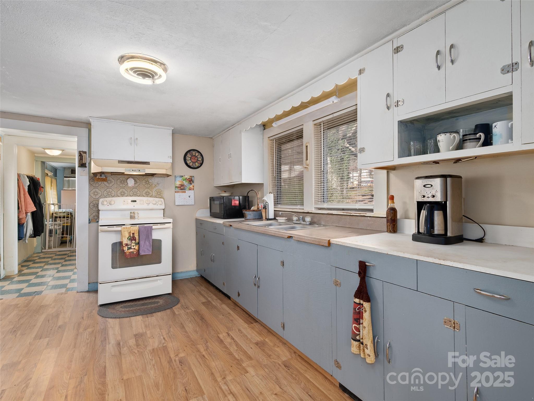 396 Will Hyatt Road Waynesville, NC 28786 - Photo 12 of 23 a kitchen with stainless steel appliances a sink and cabinets