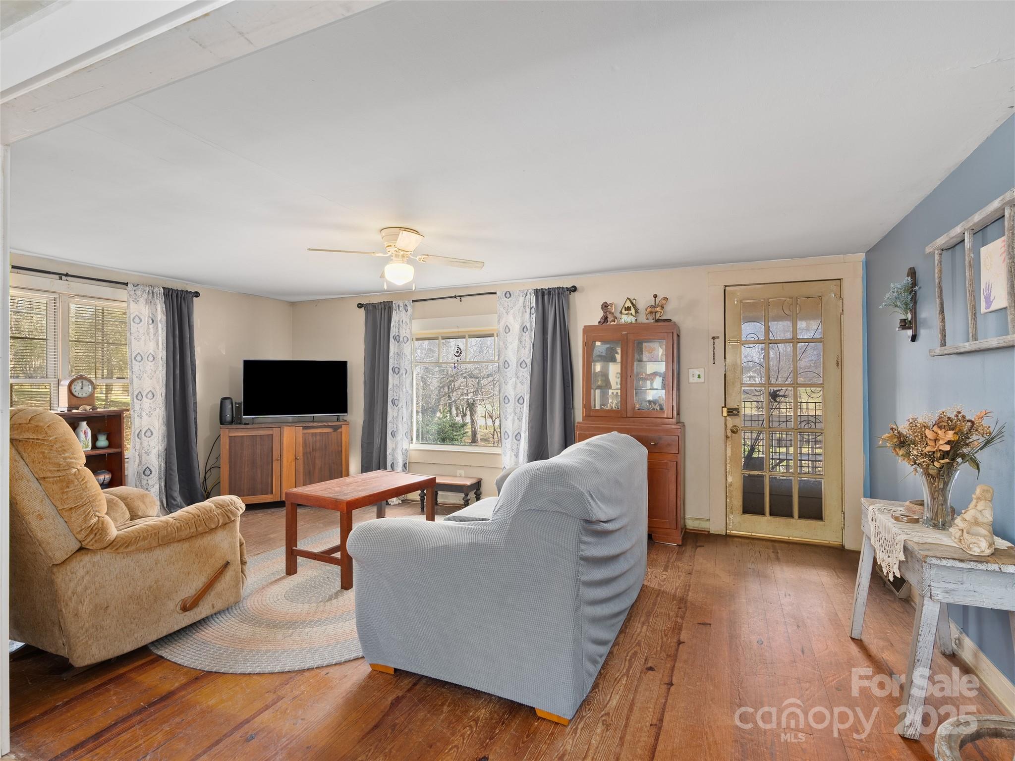 396 Will Hyatt Road Waynesville, NC 28786 - Photo 3 of 23 a living room with furniture and a flat screen tv