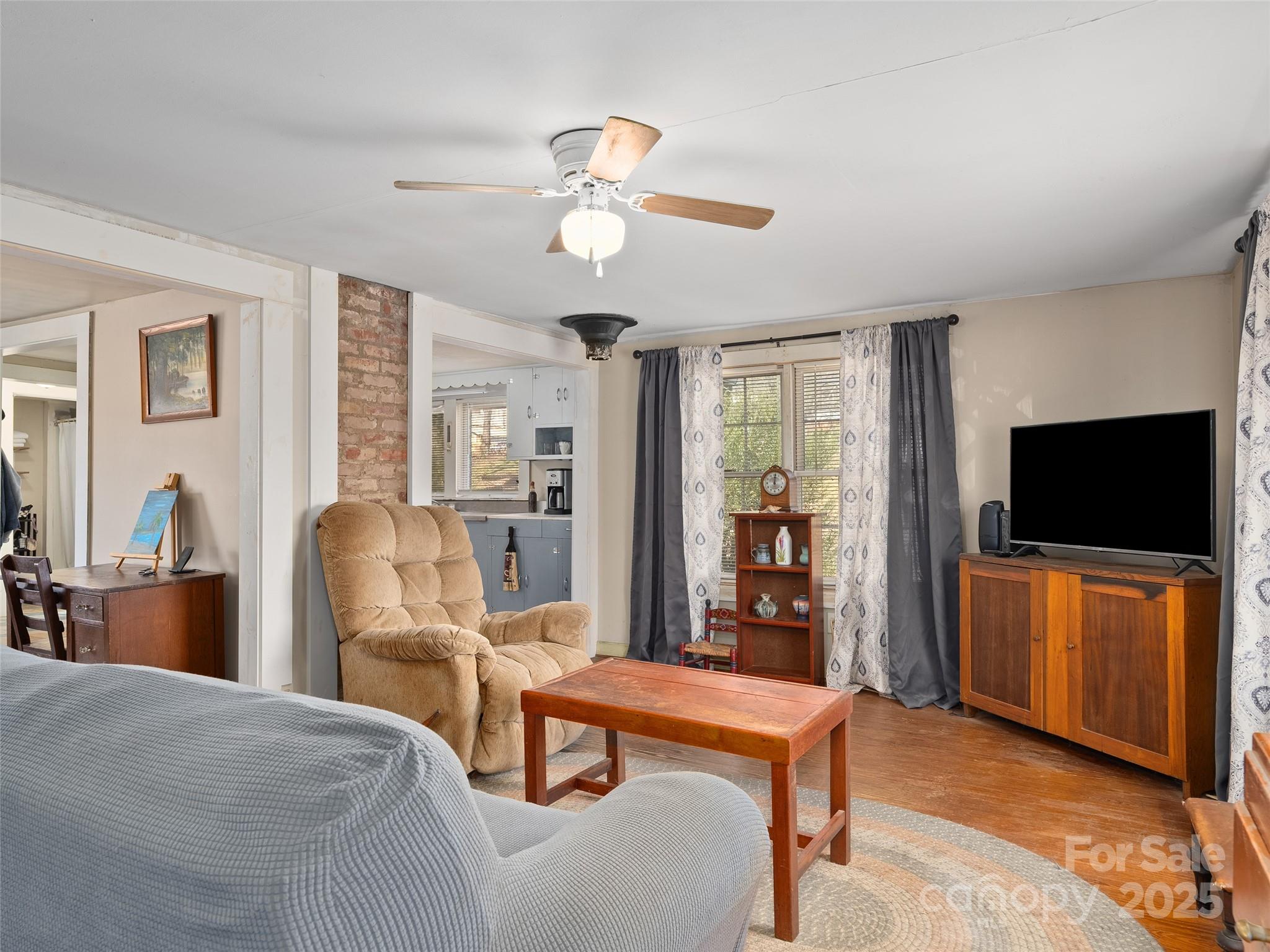396 Will Hyatt Road Waynesville, NC 28786 - Photo 4 of 23 a living room with furniture and a flat screen tv
