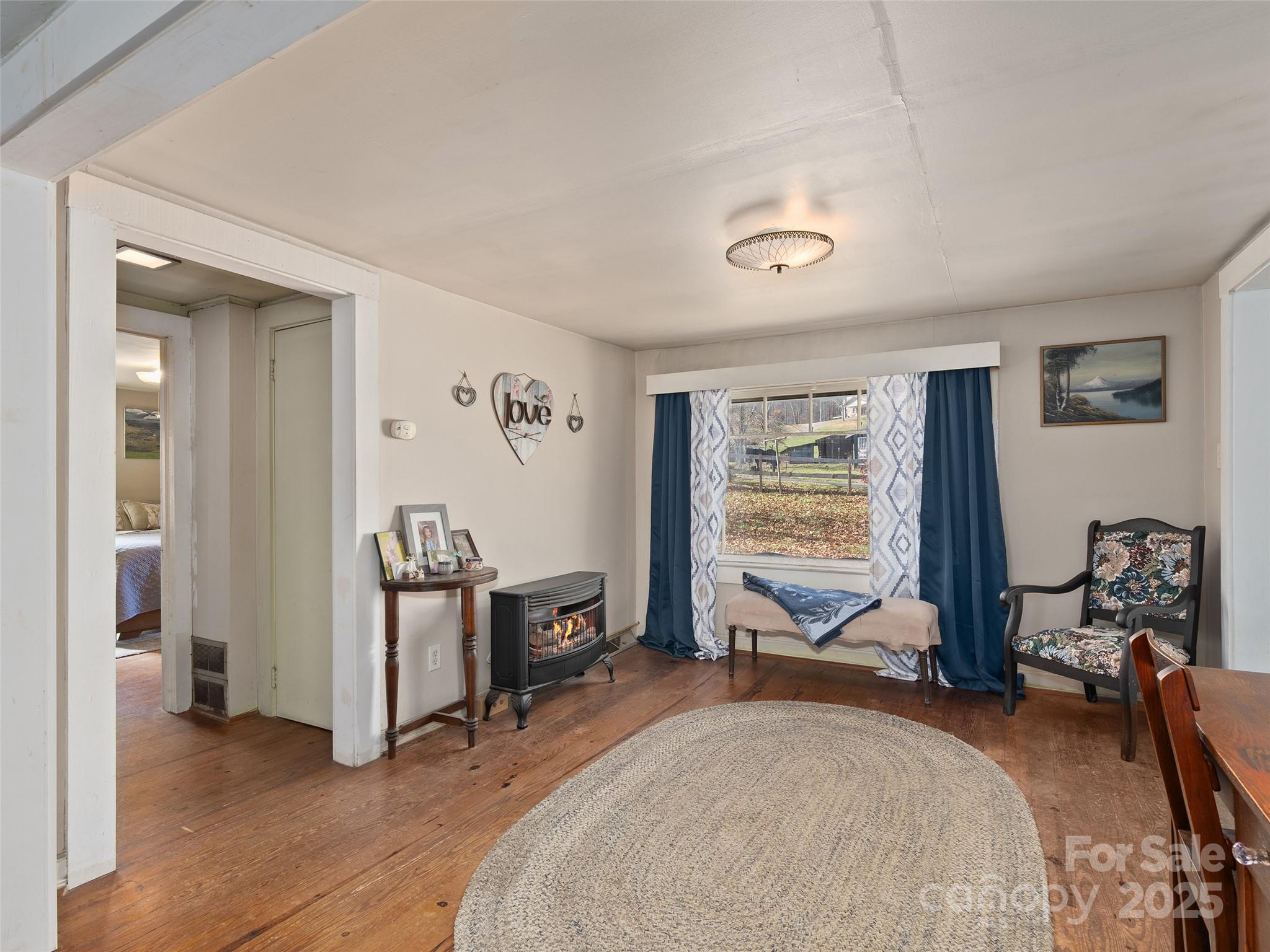 396 Will Hyatt Road Waynesville, NC 28786 - Photo 8 of 23 a bedroom with furniture and a window