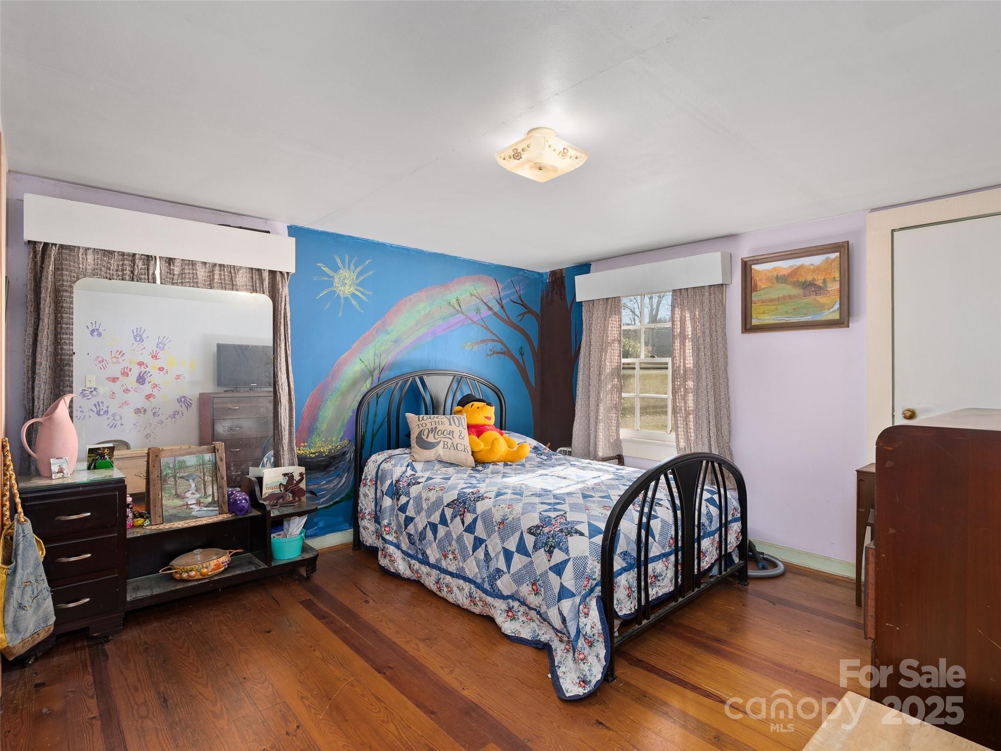 396 Will Hyatt Road Waynesville, NC 28786 - Photo 10 of 23 a bedroom with a bed and wooden floor