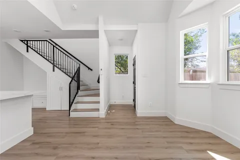 a view of entryway and hall with wooden floor