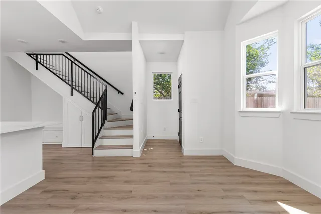 a view of entryway and hall with wooden floor