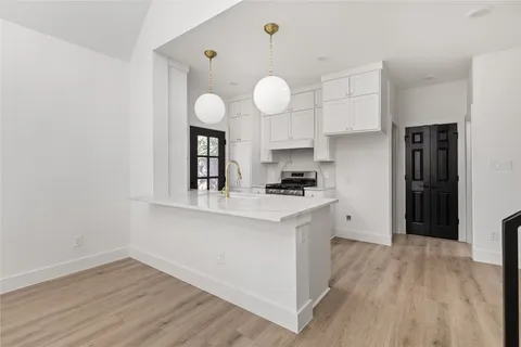 a kitchen with cabinets and stainless steel appliances