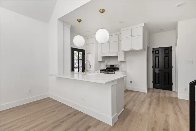 a kitchen with cabinets and stainless steel appliances