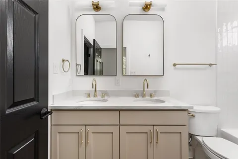 a bathroom with 2 sink and a mirror