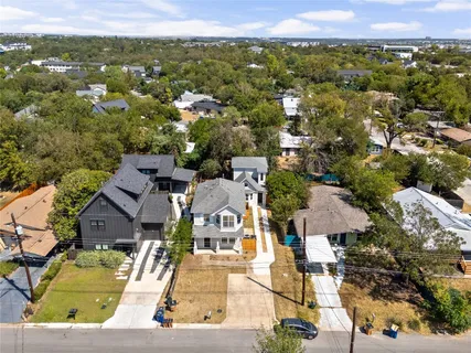 an aerial view of residential houses with outdoor space