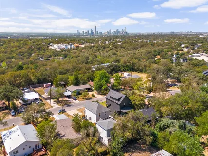 an aerial view of residential houses with city view