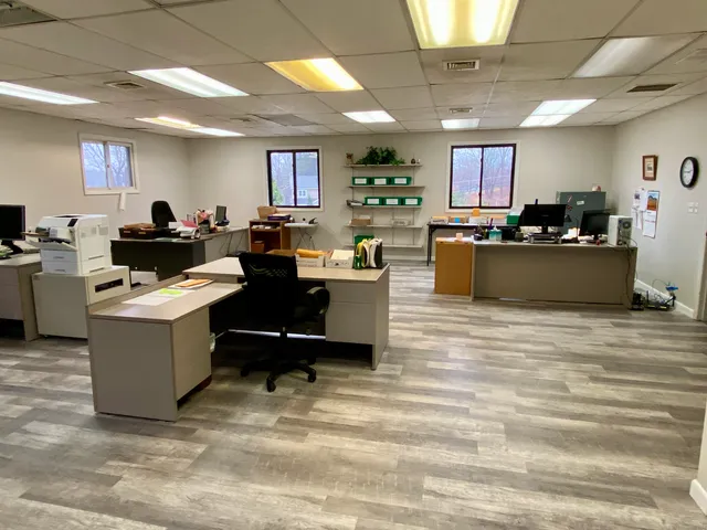 a living room with furniture kitchen view and a window