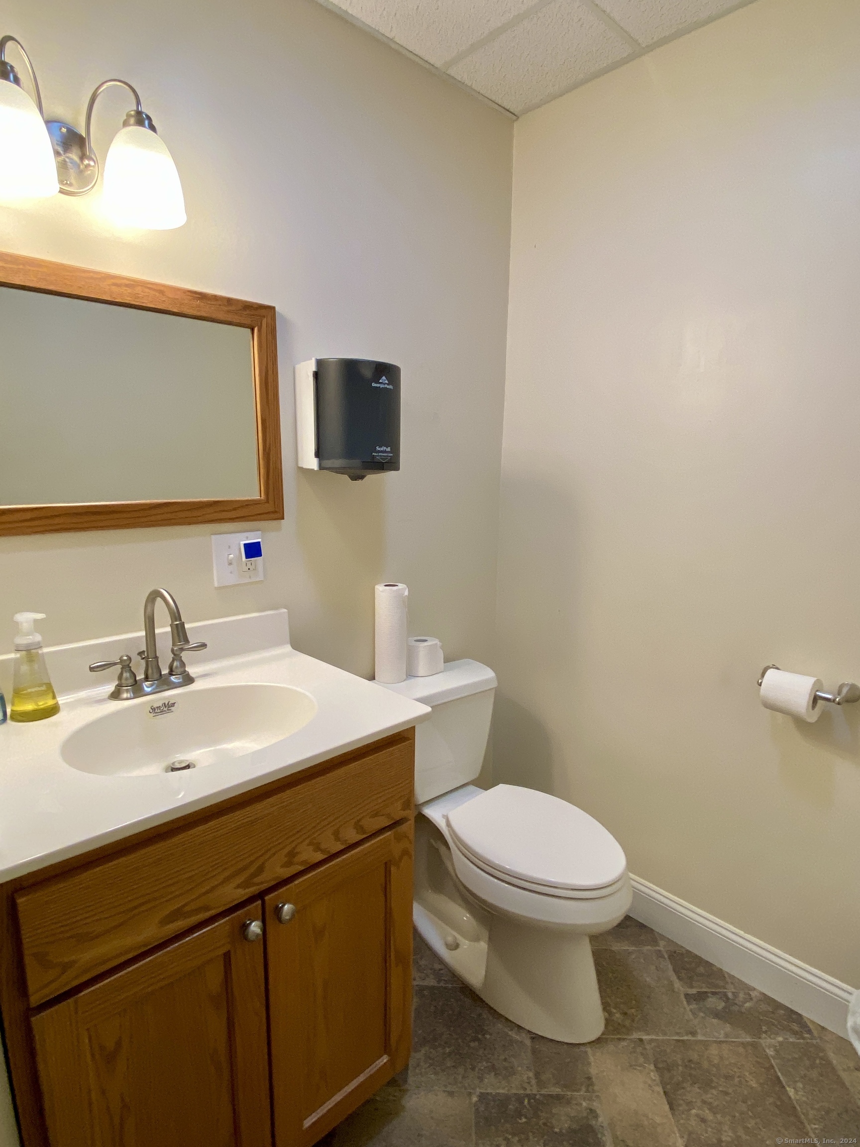 117 Hartford Turnpike Tolland, CT 06084 - Photo 6 of 6 a bathroom with a toilet sink vanity and mirror