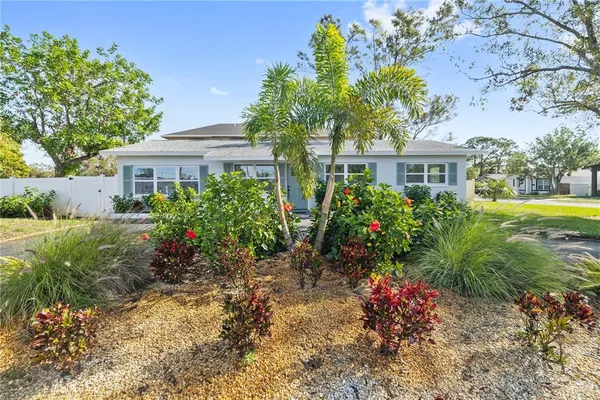 a front view of house with yard and trees around
