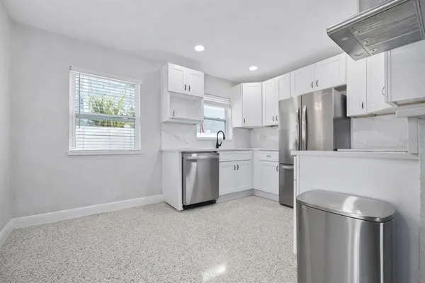 a kitchen with refrigerator cabinets and furniture