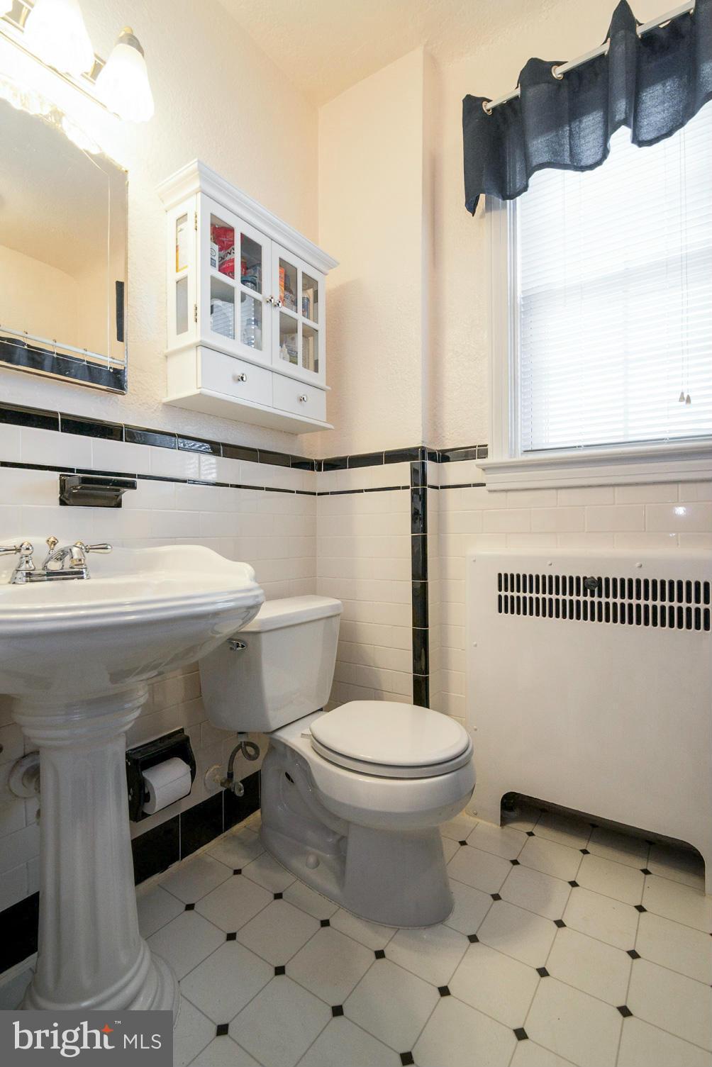 400 Murdock Road Baltimore, MD 21212 - Photo 14 of 30 a bathroom with a sink a toilet and a mirror