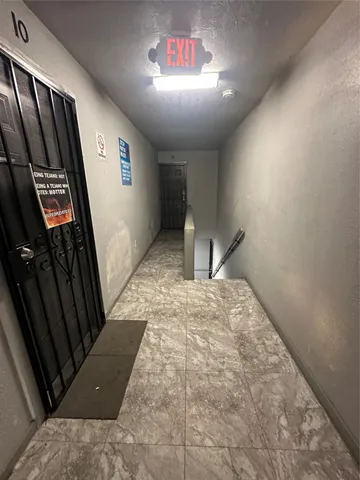 a view of a hallway in a house with wooden floor