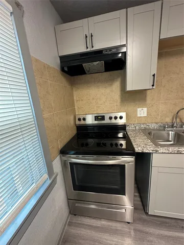 a view of wooden floor in a kitchen