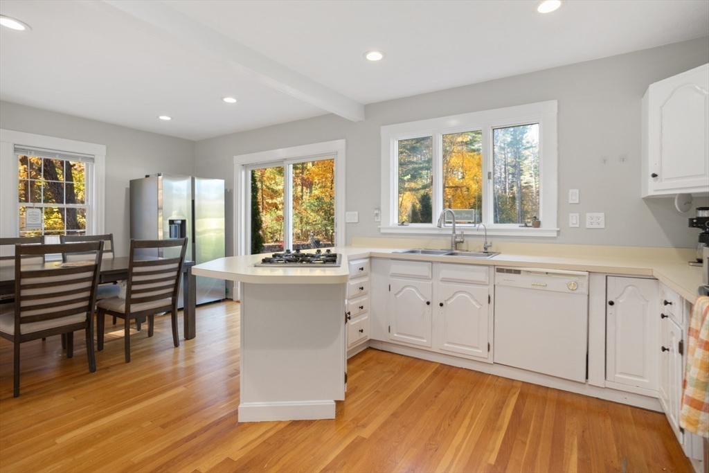 928 Main Street Lynnfield, MA 01940 - Photo 12 of 41 a large white kitchen with wooden floors and white walls