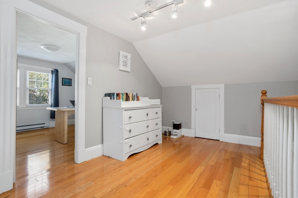 928 Main Street Lynnfield, MA 01940 - Photo 22 of 41 a view of a bedroom with cabinet mirror and window