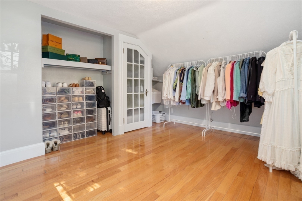 928 Main Street Lynnfield, MA 01940 - Photo 24 of 41 a view of walk in closet with clothes and shoes
