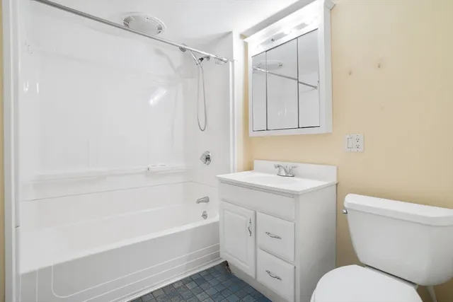 a spacious bedroom with a bed and a couch