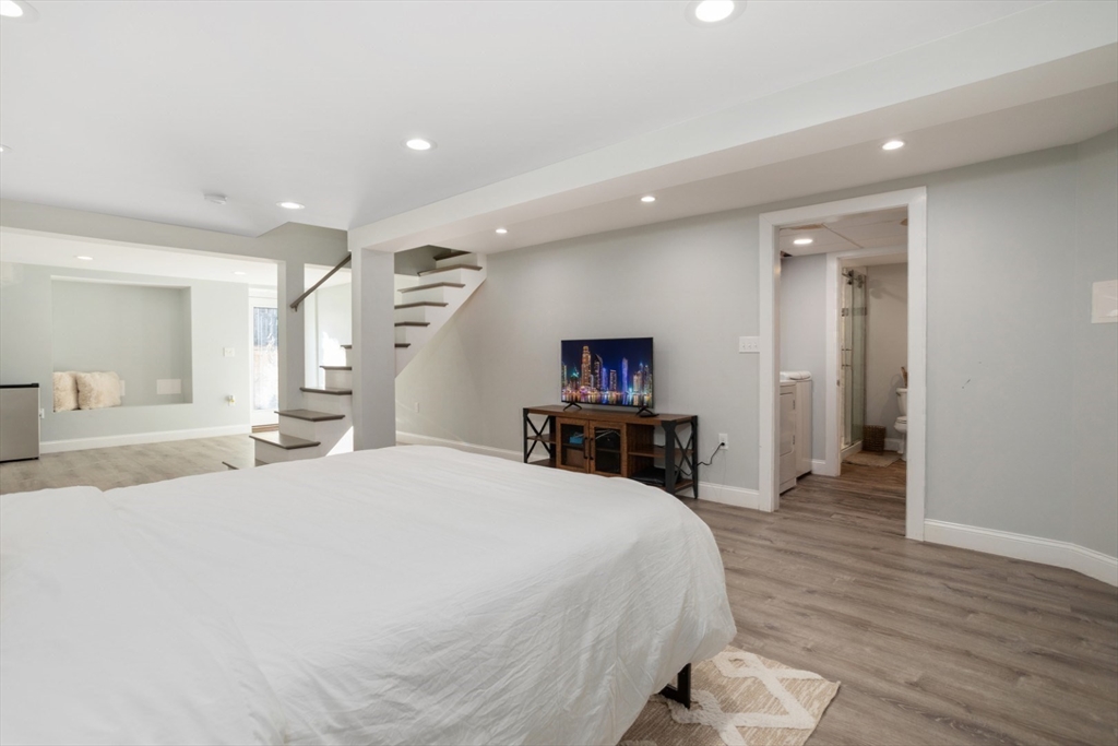 928 Main Street Lynnfield, MA 01940 - Photo 33 of 41 a large bedroom with a bed and a flat screen tv