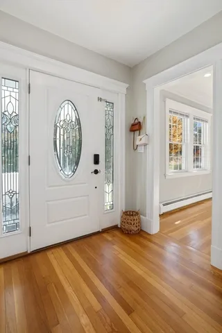 a large white kitchen with wooden floors and white walls