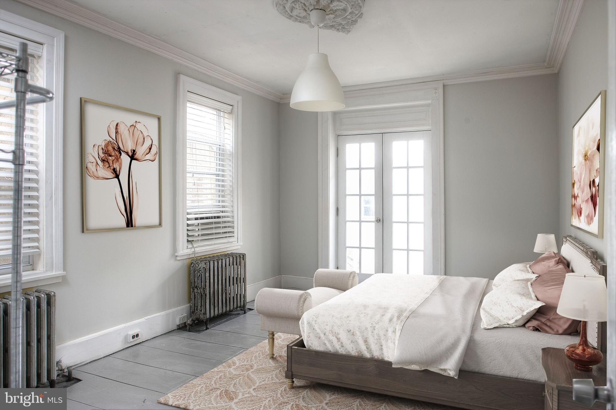 1228 Catharine Street Philadelphia, PA 19147 - Photo 13 of 32 a bedroom with a bed and a window