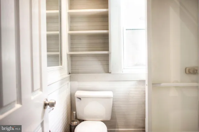 a view of a hallway with wooden floor and stairs