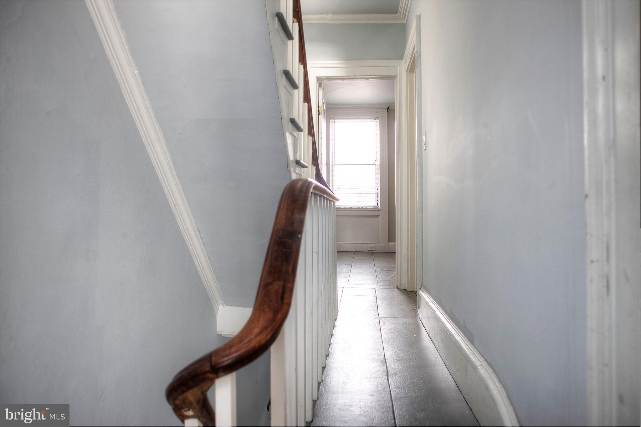 1228 Catharine Street Philadelphia, PA 19147 - Photo 16 of 32 a view of a hallway with wooden floor and stairs