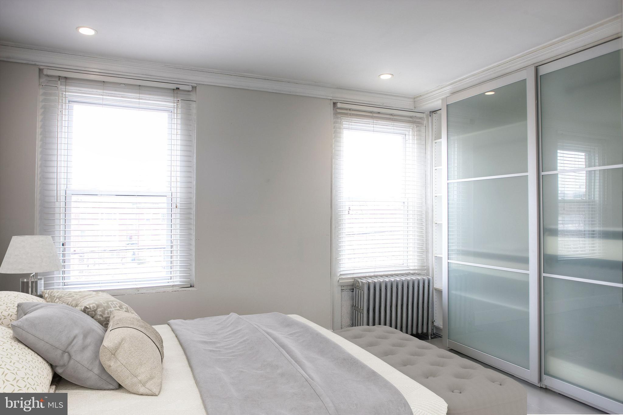 1228 Catharine Street Philadelphia, PA 19147 - Photo 20 of 32 a bedroom with a bed and a window