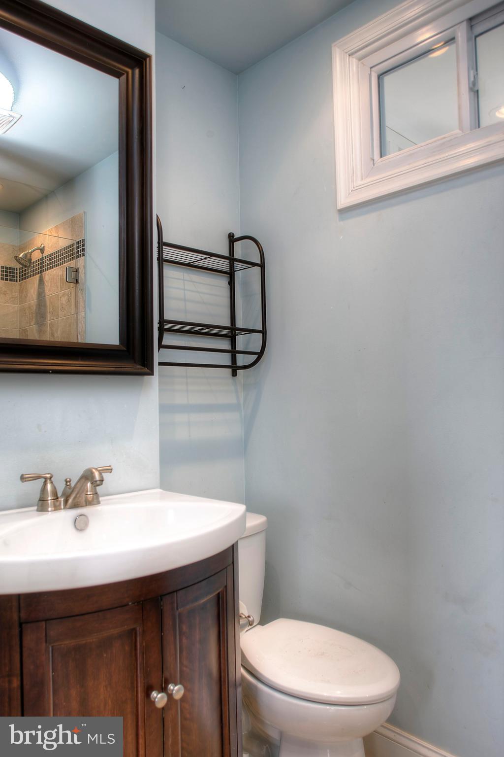 1228 Catharine Street Philadelphia, PA 19147 - Photo 22 of 32 a bathroom with a toilet a sink and mirror