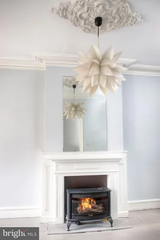 a living room with a fireplace and a chandelier