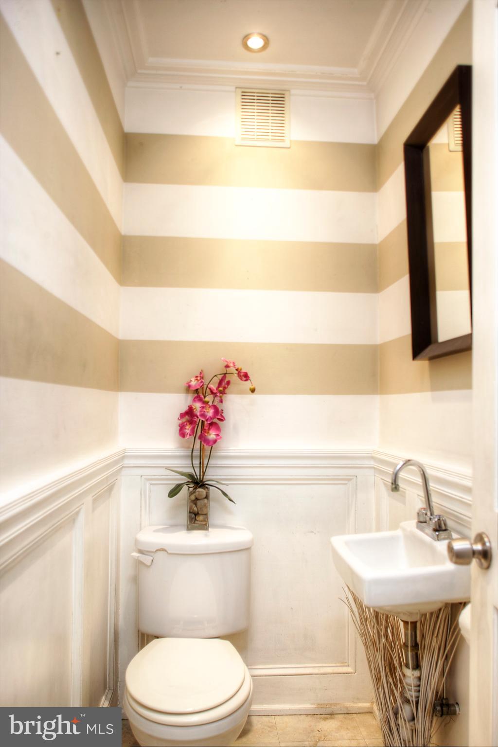 1228 Catharine Street Philadelphia, PA 19147 - Photo 8 of 32 a bathroom with a sink a toilet and a mirror