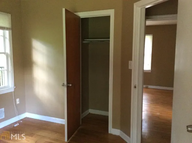 a view of a hallway with wooden floor