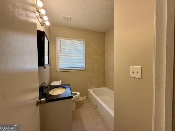 a bathroom with a sink a mirror and a bathtub