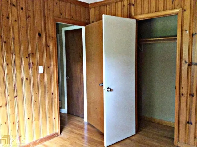 a view of a room with wooden floor